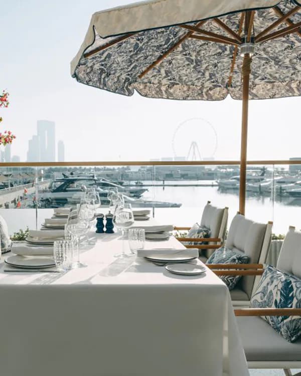 Rooftop terrace at L’Amo Bistro Del Mare in Dubai with marina view and patterned umbrella
