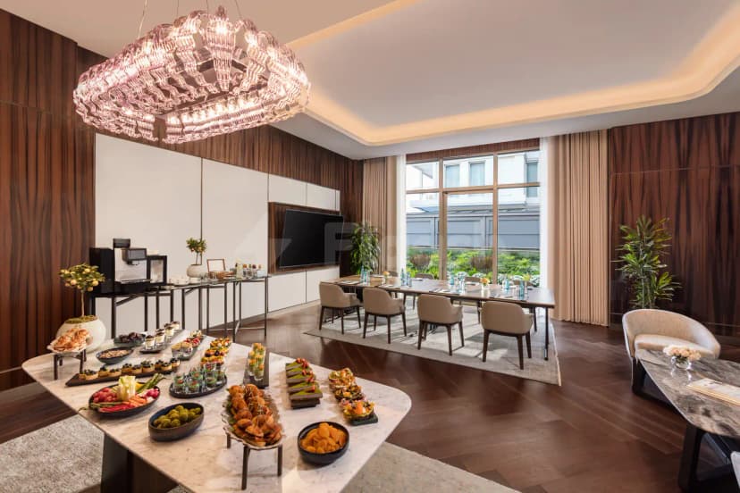Boardroom at Mandarin Oriental Downtown Dubai featuring a long table with beige chairs, a marble buffet table