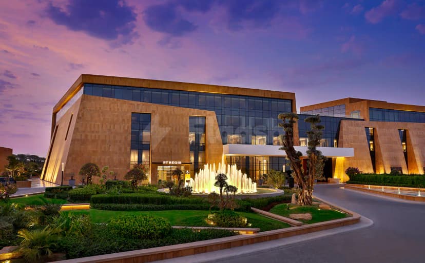 Hotel facade at The St. Regis Riyadh in Riyadh with illuminated fountain and stone cladding
