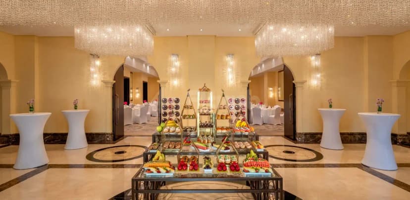 Ballroom at Shangri-La Qaryat Al Beri Abu Dhabi featuring crystal chandeliers, yellow walls, marble floor with black inlay
