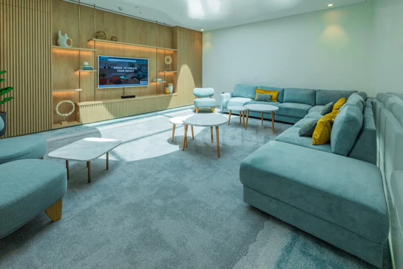 Modern lounge at Cloud Spaces Circle Mall Dubai with wooden wall paneling and mounted television