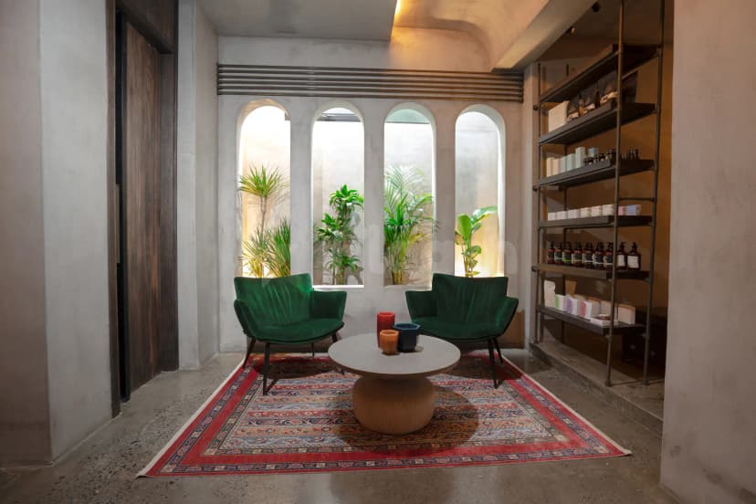 Meeting room at The Els Club Dubai Sports City featuring arched windows with potted palms and industrial metal