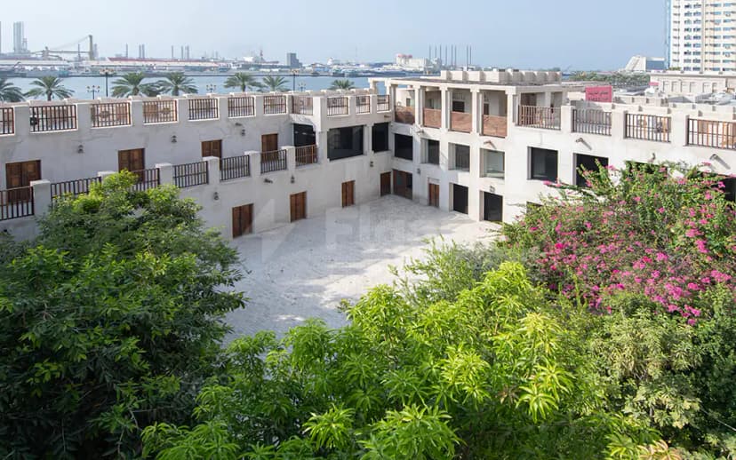 Courtyard at The Flying Saucer Sharjah in Sharjah with pink bougainvillea and sea view