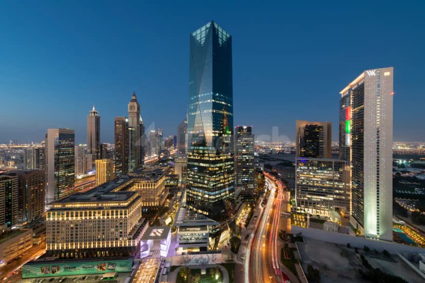 Glass skyscraper facade of ICD Brookfield Place in Dubai, featuring reflective glass exterior and vertical LED lighting strips
