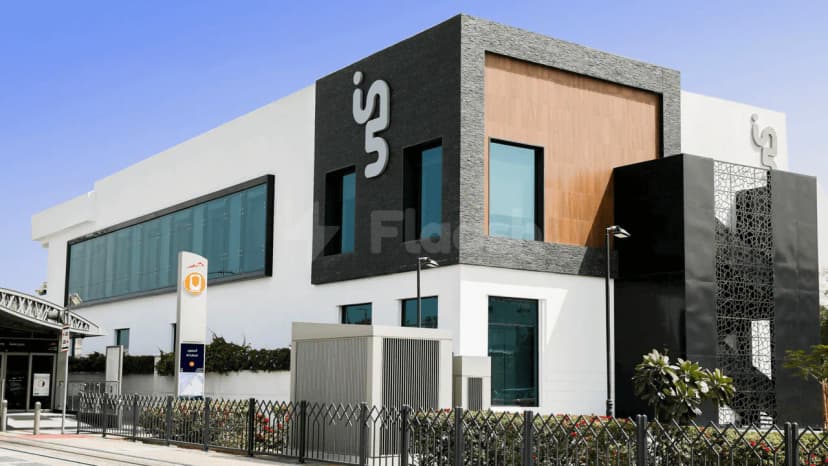 Modern facade of Conference Hall Dubai Knowledge Park featuring black textured and wooden panels, large glass windows