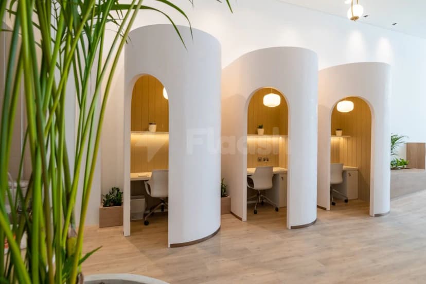 Meeting room at Cloud Spaces Circle Mall Dubai featuring white curved partitions with arched openings and wooden wall