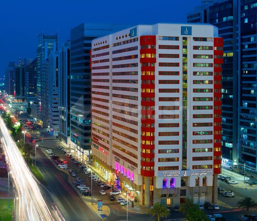 Hotel facade at City Seasons Al Hamra Hotel in Abu Dhabi with illuminated purple arches at entrance