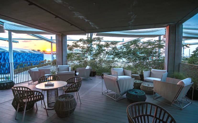 Rooftop terrace at The Nexus in Dubai with wooden deck and translucent canopy