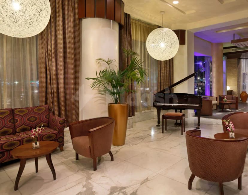 Entrance Hall at City Seasons Al Hamra Hotel Abu Dhabi featuring marble flooring, large spherical pendant lights