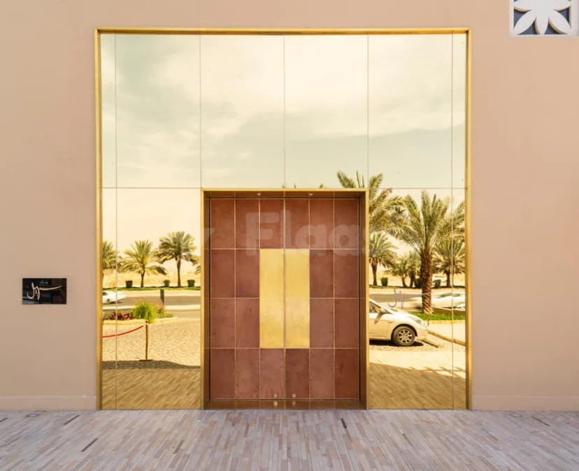 Entrance hall at Suhail Arabic Restaurant Riyadh featuring a large mirrored wall and a tiled double door