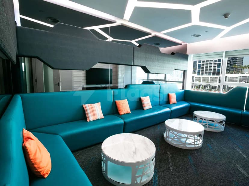 Teal leather sectional lounge at Gulf Court Hotel Business Bay in Dubai with hexagonal ceiling lighting
