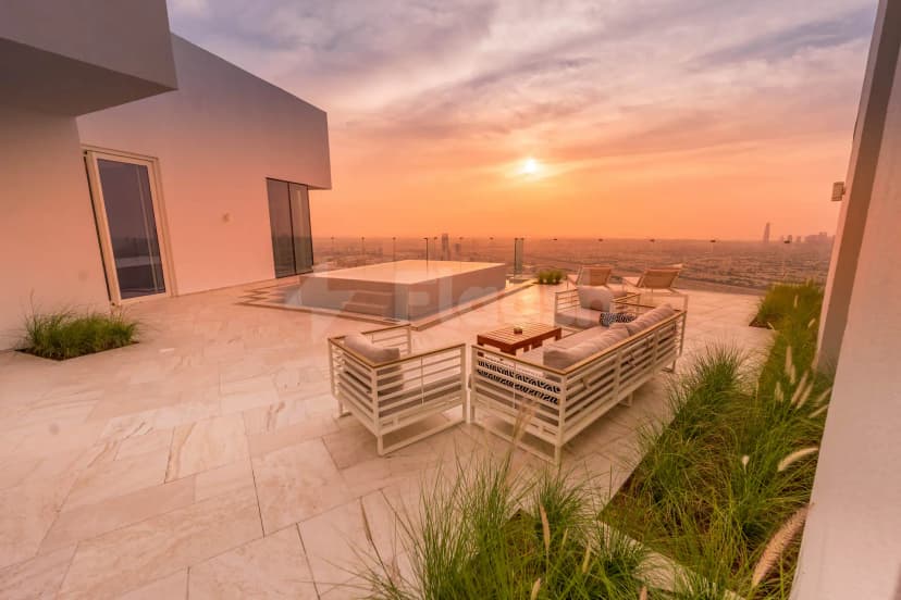 Rooftop terrace at Five Jumeirah Village Dubai featuring a rectangular pool and modern lounge seating with city skyline