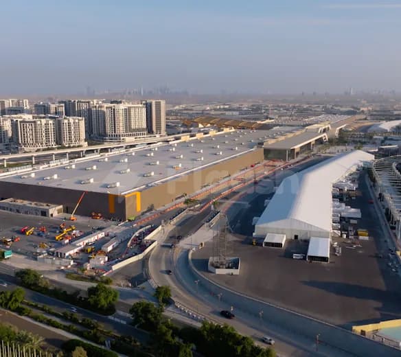 Large white tent structure at Dubai Exhibition Centre in Dubai, set on paved ground beside a curved road