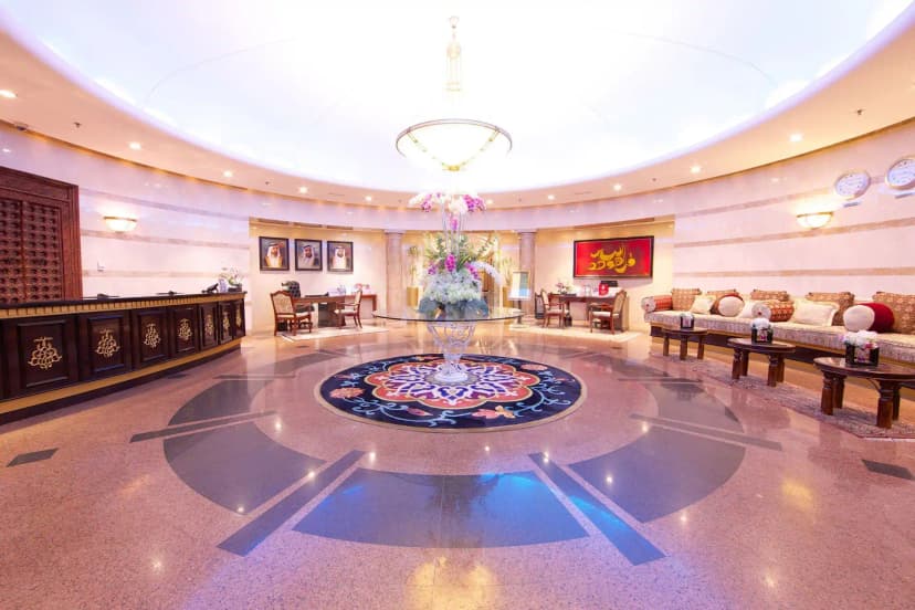 Entrance hall at Tamani Hotel Marina in Dubai with ornate wooden reception desk and gold inlay