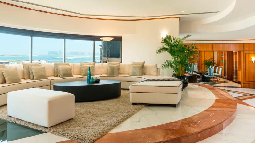 Curved lounge area at Le Royal Meridien Beach Resort & Spa in Dubai with waterfront view through floor-to-ceiling