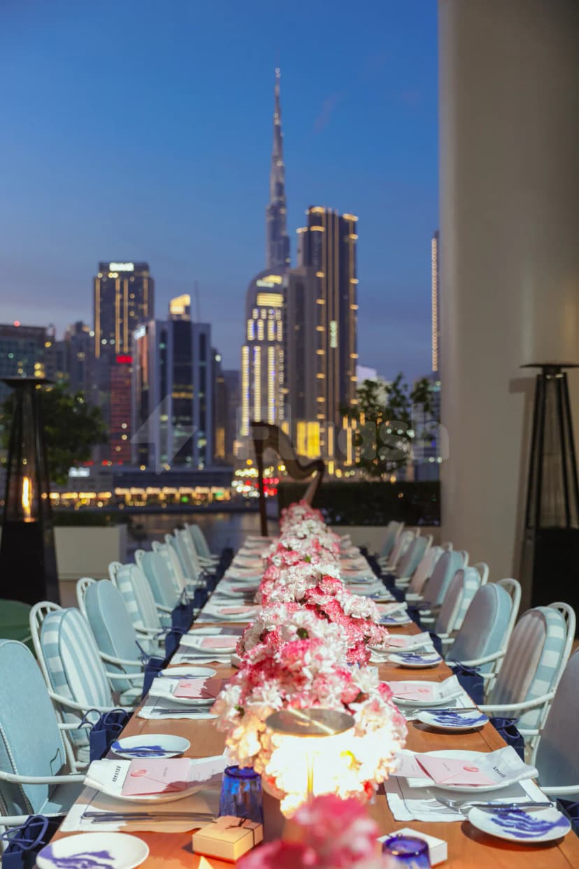 Rooftop terrace at Riviera By Jean Imbert Dubai Business Bay with Burj Khalifa view at twilight