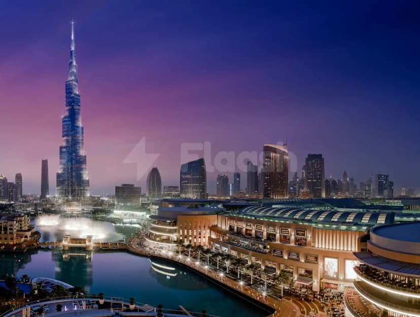 Rooftop terrace at Armani Hotel Dubai with Burj Khalifa view, illuminated fountain, and curved building facade at dusk