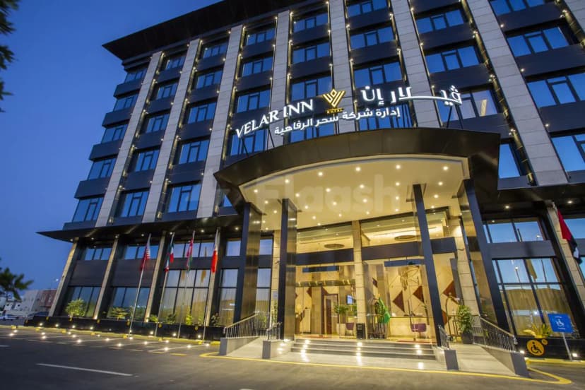 Hotel facade at Velar Inn Hotel Taif with illuminated arched entrance canopy and recessed ceiling lights