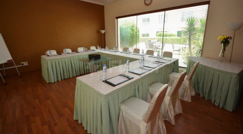 U-shaped meeting room at Coral Boutique Villas in Dubai with large window and natural light