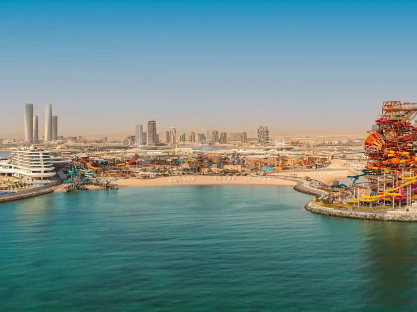 Rooftop terrace at Rixos Premium Qetaifan Island North in Doha overlooking a water park with orange and yellow