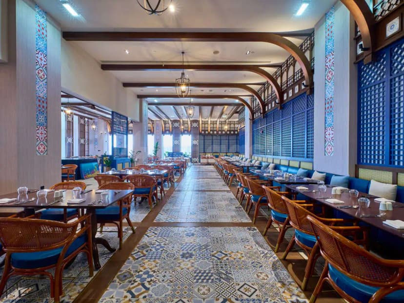 Long dining room at Rixos Premium Qetaifan Island North in Doha featuring patterned tile flooring and blue lattice
