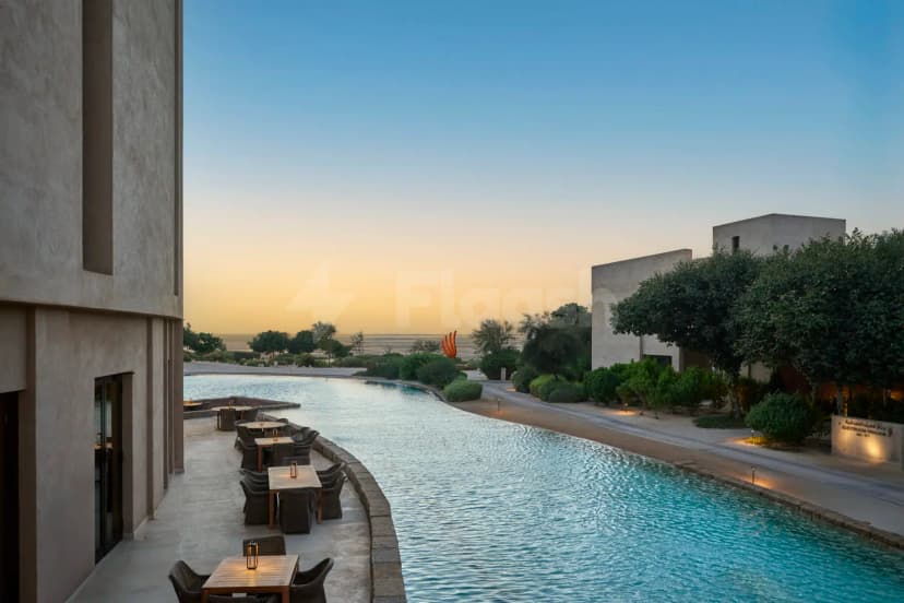 Rooftop terrace at Zulal Wellness Resort in Doha featuring a long water feature and modern beige stucco architecture
