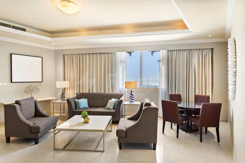 Modern lounge at Al Hamra Residence in Ras Al-Khaimah with large window overlooking water