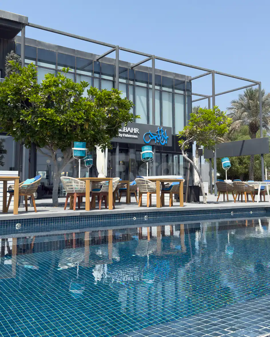 Terrace at Ibn AlBahr Seafood Restaurant in Dubai featuring a swimming pool with blue mosaic tiles