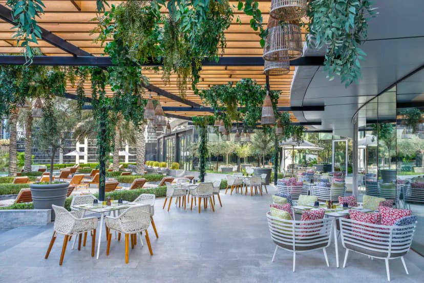 Terrace at La Brasserie Sur Le Boulevard in Dubai featuring a wooden pergola ceiling with black metal beams