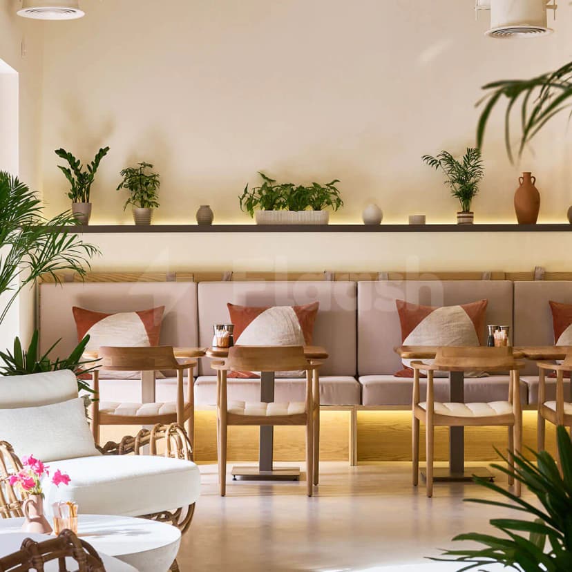Apricot Dubai Cafe Downtown Dubai features beige upholstered bench seating and wooden chairs with terracotta and cream pillows