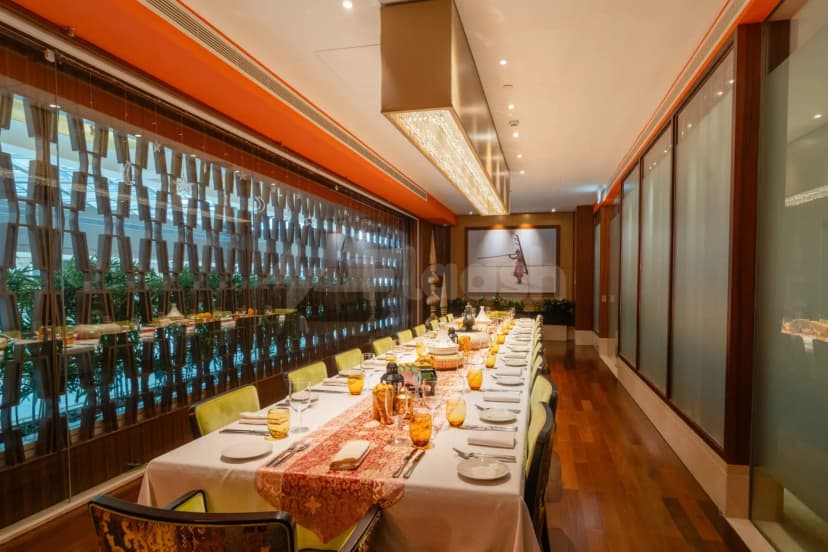 Long dining table at Namak Restaurant Abu Dhabi with hanging star decorations