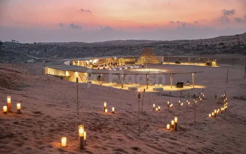 Open-air terrace at Nara Desert Escape in Dubai with thatched conical roof