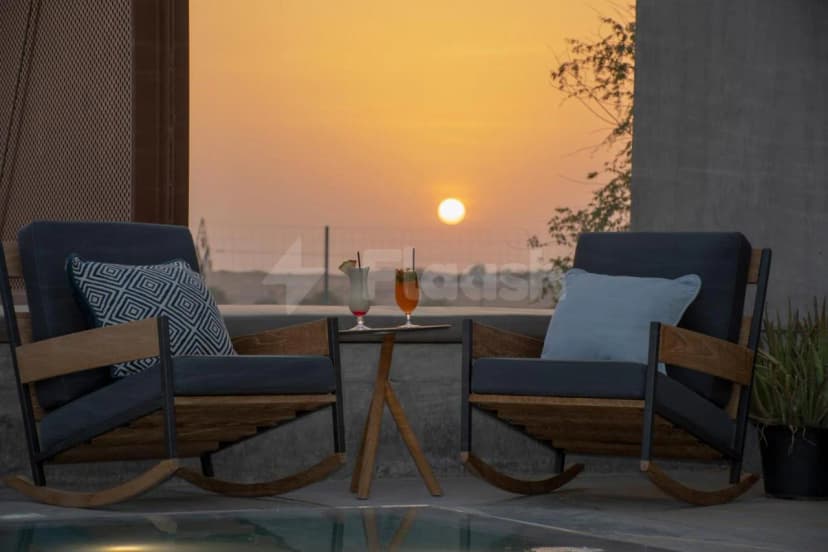 Rooftop terrace at Al Faya Retreat in Sharjah with sunset view over distant landscape
