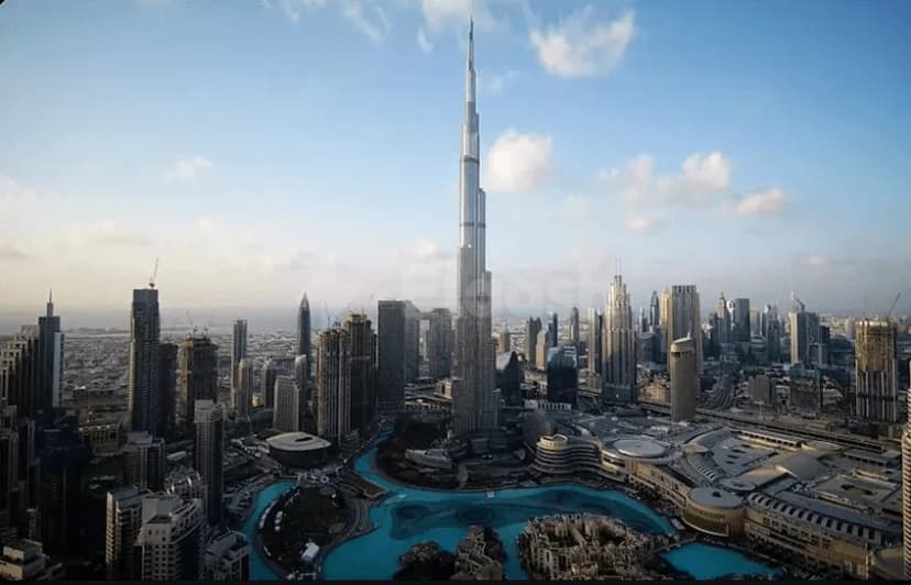 Hotel facade of Armani Hotel Dubai at Burj Khalifa with a turquoise water feature and circular fountain