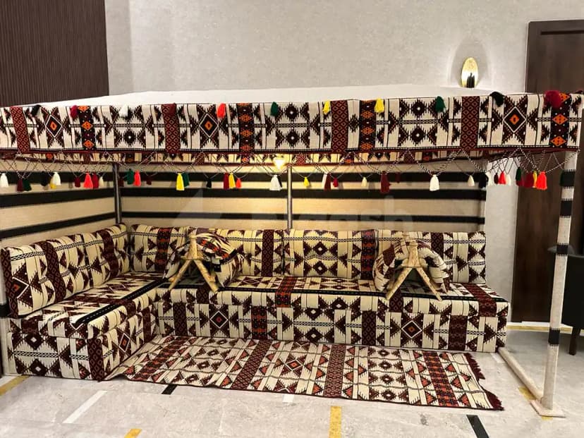L-shaped sofa with geometric textile upholstery and tassels hanging decor in a meeting room at Le Reve Hotel