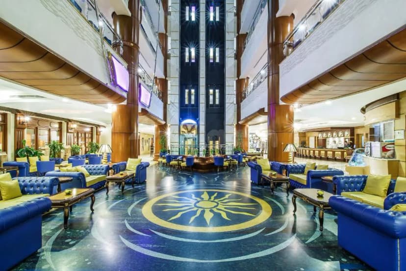 Entrance hall of Excelsior Hotel Downtown in Dubai featuring a sun motif floor design and a multi-level atrium