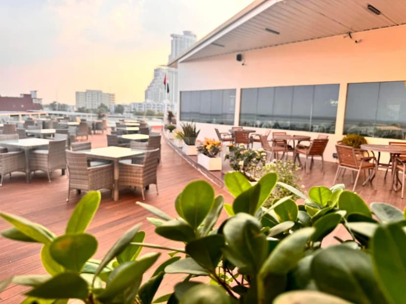 Rooftop terrace at The Sailors Fujairah in Fujairah featuring a wooden deck, wicker and wooden seating