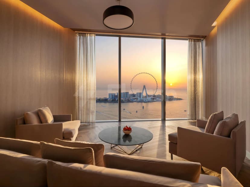 Terrace at Rixos Premium Dubai JBR Hotel featuring large glass windows and sheer curtains overlooking the Dubai Eye