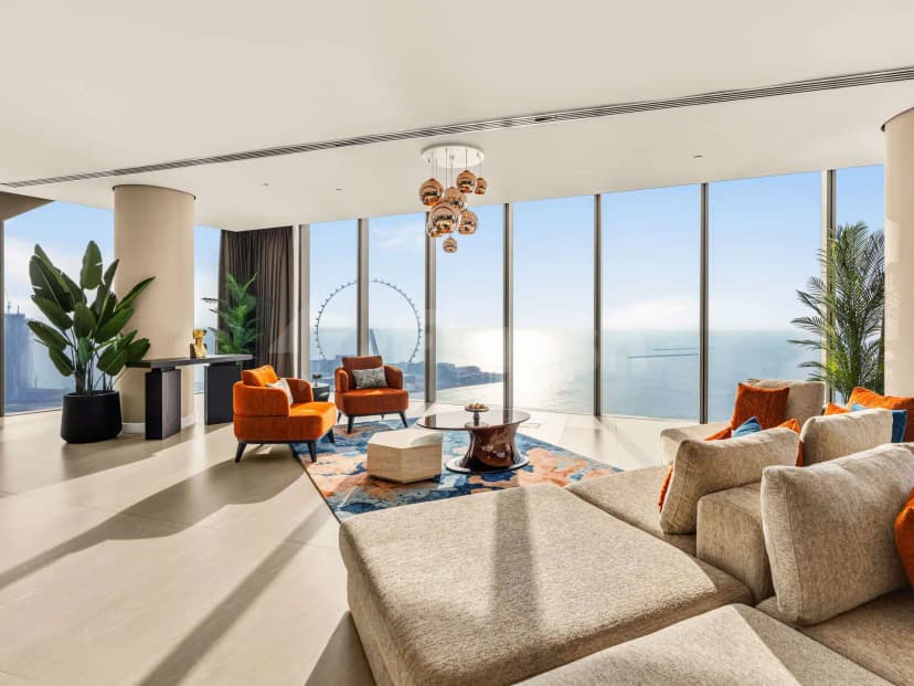 Entrance hall at Rixos Premium Dubai JBR Hotel featuring floor-to-ceiling windows with sea and Ferris wheel views