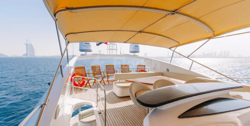 Sunseeker 82 Why Not Yacht Dubai deck with yellow canvas canopy and teak wooden flooring overlooking the sea