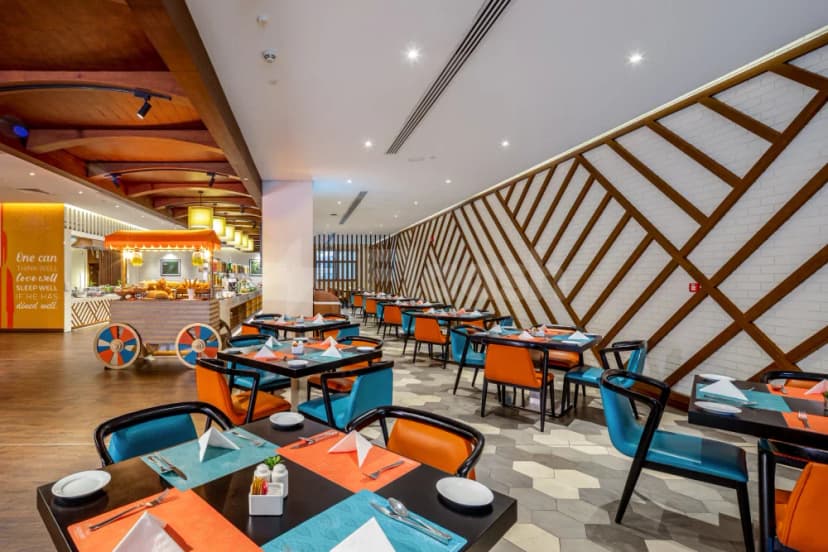 Restaurant at Flora Inn Hotel Dubai Airport with wooden lattice paneling on white brick wall