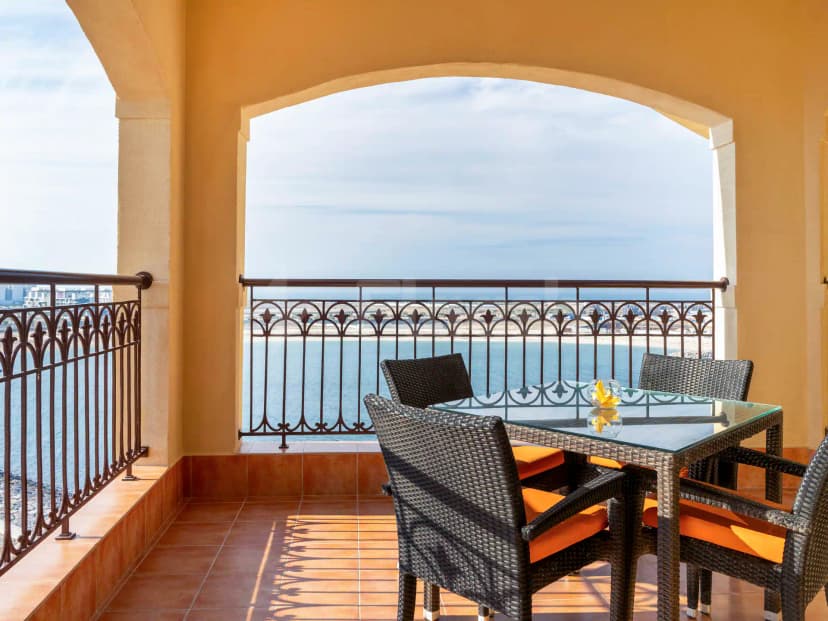 Rooftop terrace at Al Liwan Restaurant Ras Al Khaimah featuring an arched opening and wrought iron railing overlooking