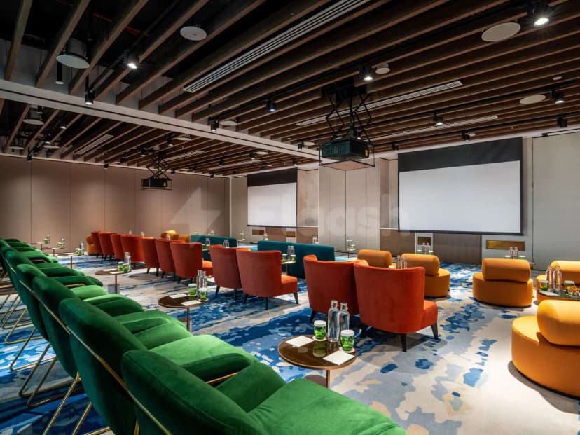 Meeting room at SO Ras Al Khaimah Hotel & Resort featuring wooden ceiling beams and two projection screens