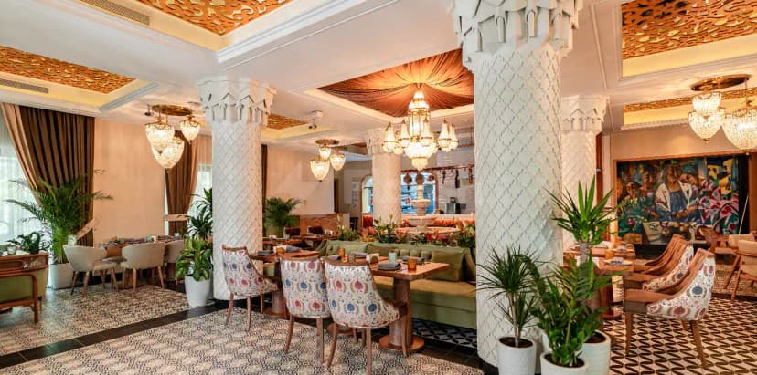 Grand Zor Restaurant Dubai features ornate white columns and patterned ceiling panels in its main dining area