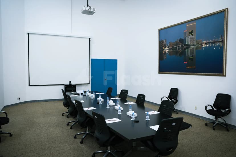 Boardroom at Jeddah International Exhibition & Convention Center featuring a black table, black chairs, a projection screen
