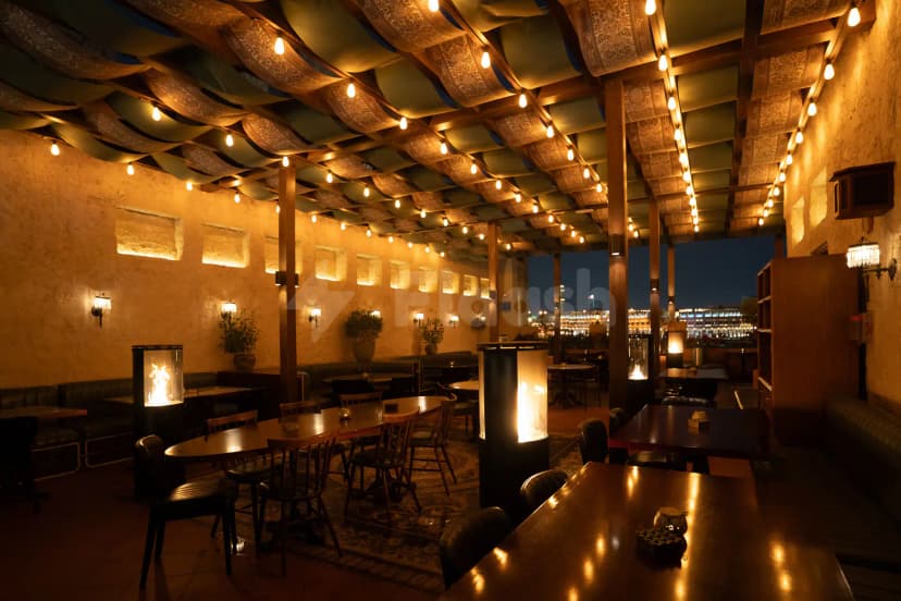 Rooftop terrace at Berenjak Acurio Restaurant Dubai featuring patterned fabric ceiling canopy and freestanding glass fireplaces with city