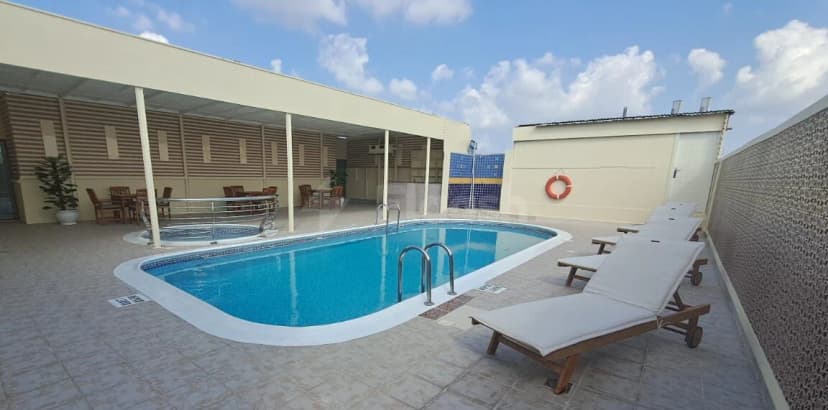 Rectangular swimming pool at Grand Central Hotel in Dubai with white tiled edge and metal ladder