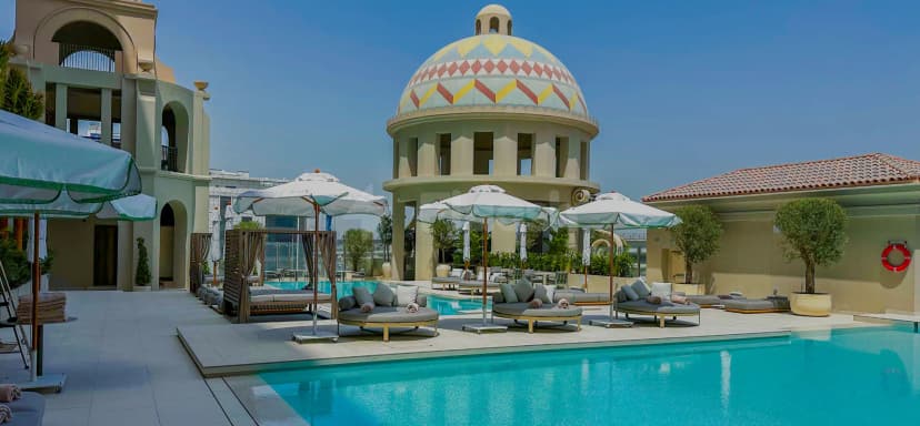 Rooftop terrace at Vera Versilia Dubai featuring a swimming pool and a distinctive domed structure with geometric patterns