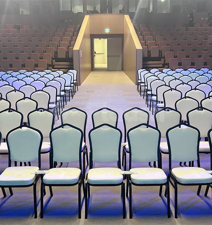 Rows of chairs in the Connect Conference Centre meeting room at Expo City Dubai with central aisle