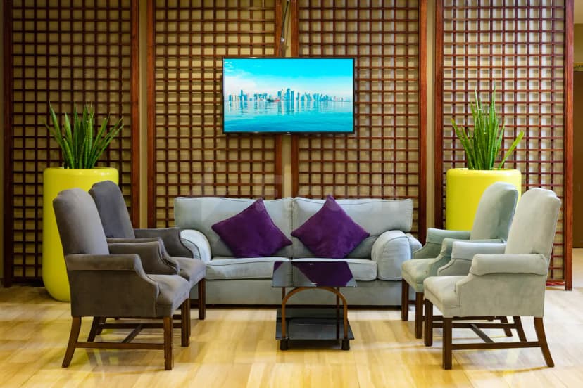 Reception lounge at Treffen House Doha in Doha with wooden lattice wall backdrop